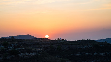 Naklejka na ściany i meble Beautiful Sunset in mountain village of Cyprus.