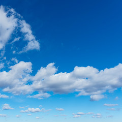 group of white cumulus clouds in the blue sky as a natural background