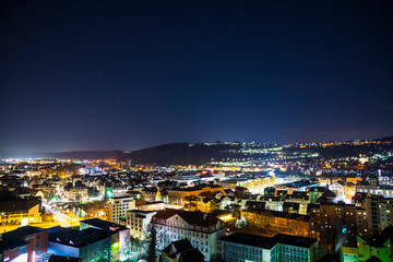 Fototapeta na wymiar Germany, Dark starry sky over old town buildings of medieval city esslingen am neckar, aerial view above the houses and roofs by night