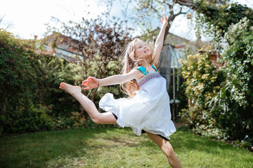 little girl dancing in garden