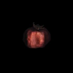 Pomegranate on black background. Closeup red dry pomegranate Isolated on a black square background. Philosophical and artistic photo. The image dissolves in the dark.