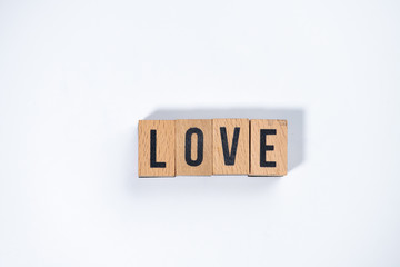 " LOVE " text made of wooden cube on  White background.
