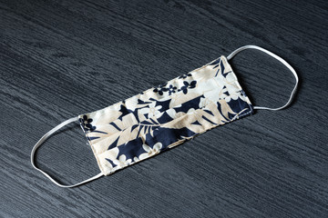 Disposable surgical face mask in tropical pattern design use for cover the mouth and nose, for protection against flu, corona virus(COVID-19) and other diseases on white background.