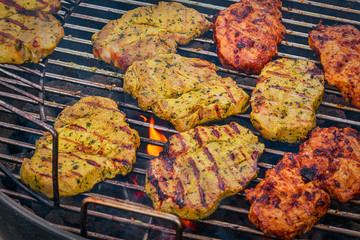 Grilled pork chops with spices on a hot grill