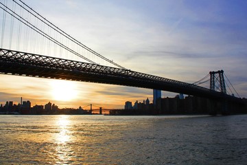 Fototapeta na wymiar New york, USA - 20/12/2019: williamsburg bridge in New York Manhattan skyscrapers behind at sunset - stock photo