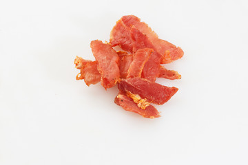 Meat smoked jerky - raw meat sausage meat. Close up view on tasty sliced Chicken basturma on parchment on a wooden board on a wooden background in a composition with spices. Beer snack. Pastirma