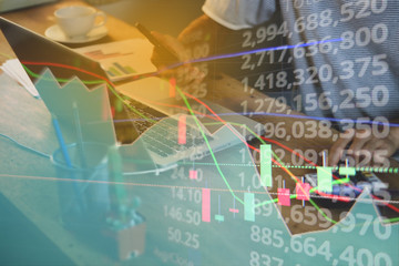 Double exposure of stock market graph and business desk for finance investment and business. Investment and economic concept