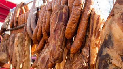 Dried meat and sausages offered for sale in street shops.