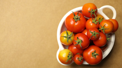 tomatoes on brown background. Top view, Copy space for the ads