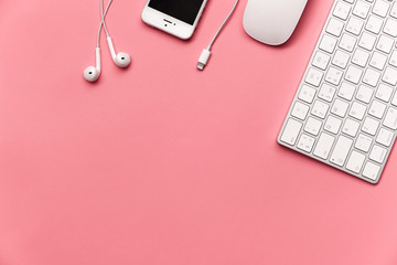 Flat lay from computer and telephone accessories on a pink background. Space for text.