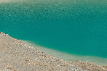 Fototapeta na wymiar turquoise water and white shore in a kaolin quarry