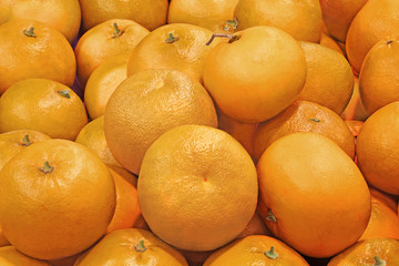 Pomelit citrus fruit at a farmers market. Full frame