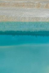 turquoise water and white shore in a kaolin quarry