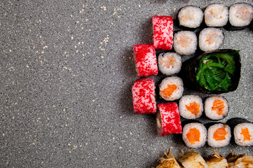 Half set of various rolls and sushi. Hats from the sauce. Baked rolls. View from above