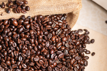 Close-up fresh roasted coffee beans in brown sack.