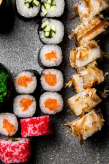 Rolls with fish and tuna chips in a large set. Gray background. Photo for the menu