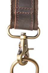 Genuine leather bag strap with a carabiner fastened on the ring. Isolated on a white background