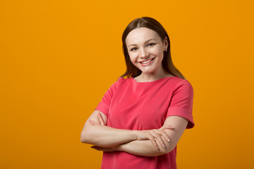 Obraz premium beautiful young woman in a pink dress on a yellow background