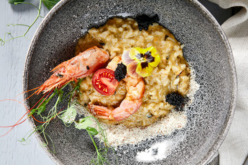 Risotto with seafood in gray bowl