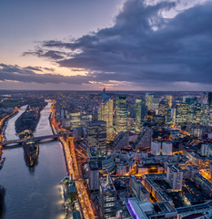 Aerial view of la defense skyscraper complex after sunset with lights on in Paris