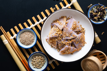 Healthy food concept Vegan Gluten free Homemade Asian fried glutinous rice flat pancake with sesame and sunflower seeds on black baclground with copy space