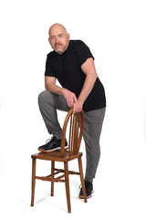 man standing with a chair in white background