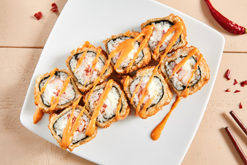 Rolls with shrimps, cream cheese, tomatoes and Spicy sauce in white plate top view