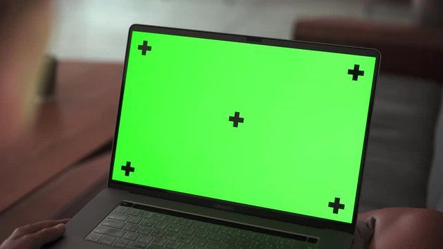  Zoom In On Laptop Green Screen Mockup Girl Lying Down With Notebook On Couch And Watching On Screen