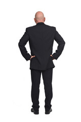full portrait of a man from behind on white background, hands on hip