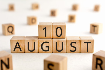 August 10 - from wooden blocks with letters, important date concept, white background random letters around