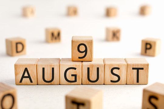 August 9 - from wooden blocks with letters, important date concept, white background random letters around