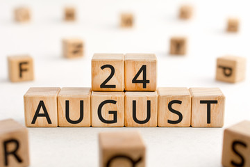 August 24 - from wooden blocks with letters, important date concept, white background random letters around