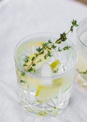Glass of water with lime and thyme