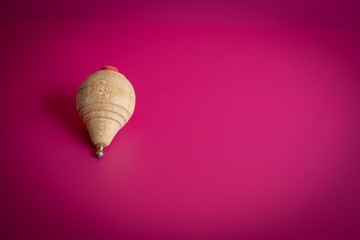 wooden spinning top on background