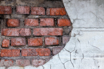 Aged red brick wall with a crack. Grunge style. Creative photo for the designer. Copy space. ragged , the problem of major repairs of houses