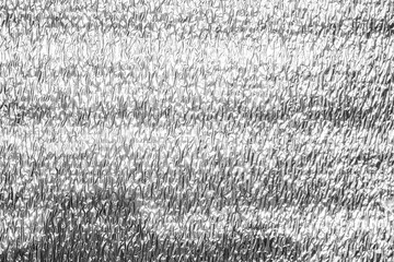 foil from a building insulation close-up. shiny gray metal background. 