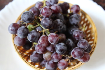Group of grapes in a small fruit basket.