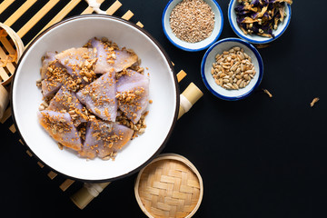 Healthy food concept Vegan Gluten free Homemade Asian fried glutinous rice flat pancake with sesame and sunflower seeds on black baclground with copy space