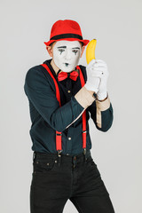 Clown with red suspenders and red hat on white background