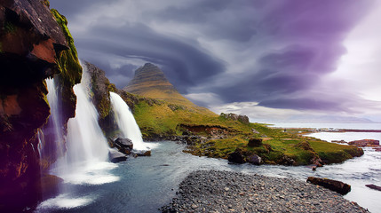 Kirkjufell waterfall and mountain with colorful dramatic sky during sunset, iceland. Amazing nature landscape. Iconic location for landscape photographers. creative artistic image. postcard © jenyateua