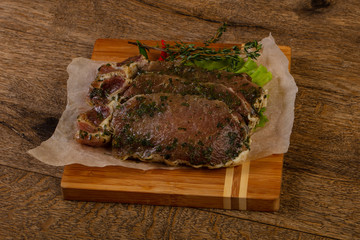 Raw marinated pork steak