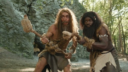 Aboriginal wild caveman of prehistoric period hunting for animal food in the forest. Primitive homo sapiens. Evolution acnestors.
