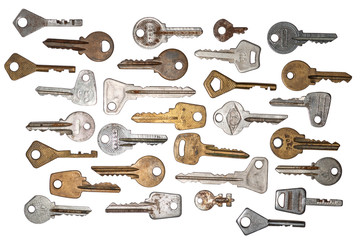 Set of various old worn 20th century brass and steel keys isolated on white