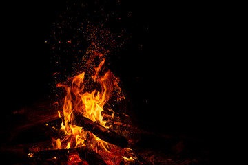 Bonefire with sparks on black with free space