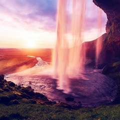 Impressive scenery of the majestic Icelandic waterfall Seljalandsfoss at sunset. Amazing landscape with dramatic picturesque sky. Iceland the most beautiful and best travel place. Beauty of World