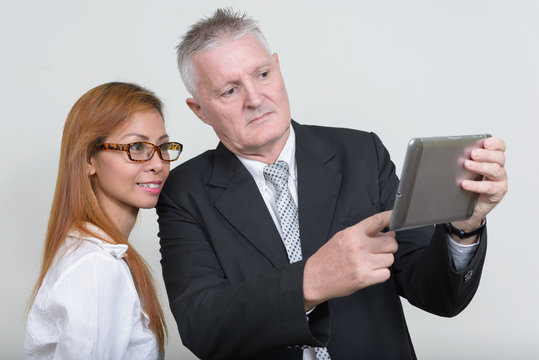 Happy mature multi ethnic business couple working together