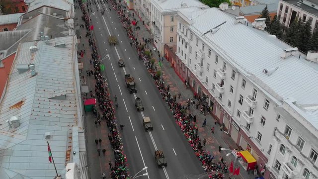 Gomel, Belarus - 05/09/2019: Military vehicles in a festive parade on Victory Day along the main street of the city, top view