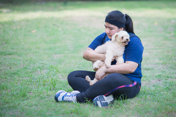 Young chinese woman outdoors holding dog