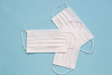 Surgical mask with rubber ear straps. Typical 3-ply surgical mask to cover the mouth and nose. Procedure mask from bacteria. Protection concept.