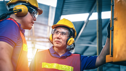 portrait of two Asian industrial workers in the warehouse.